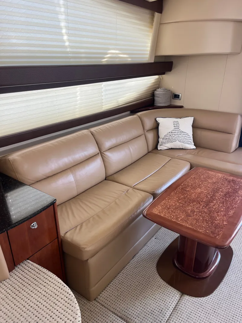 Slide: The Image of Luxurious interior of 2008 Meridian 391 Sedan with beige leather seating and wooden table. - 23