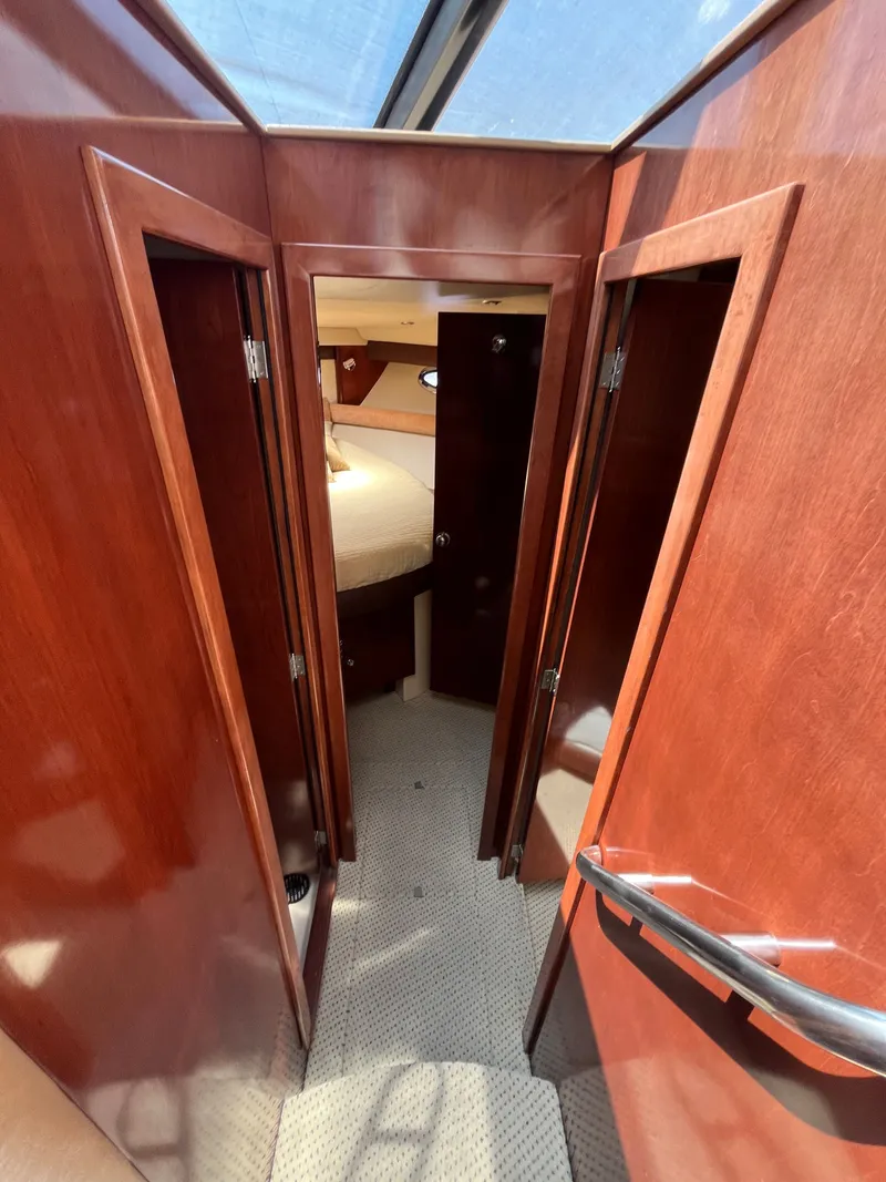 Slide: The Image of Interior hallway of 2008 Meridian 391 Sedan yacht with wooden doors and carpeted floor. - 26