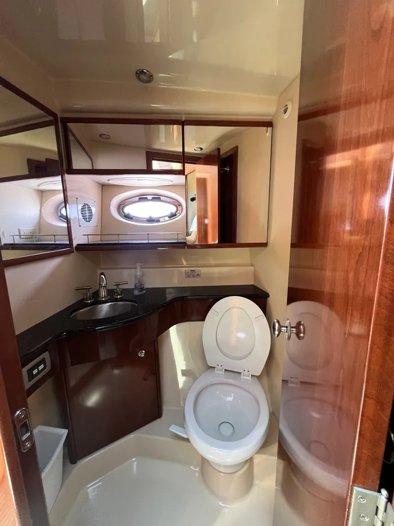 Slide: The Image of 2008 Meridian 391 Sedan yacht bathroom with sink, toilet, and mirror. - 28