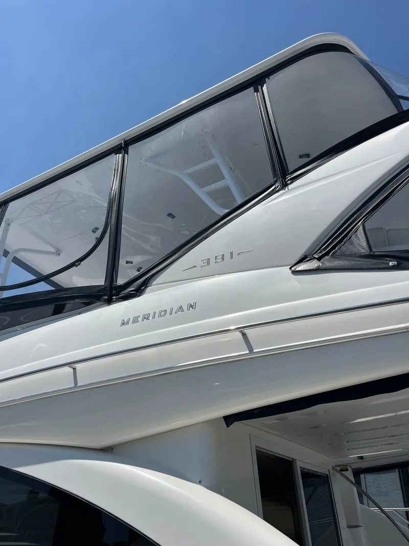 Slide: The Image of 2008 Meridian 391 Sedan yacht, featuring sleek design and modern windows against a clear blue sky. - 4