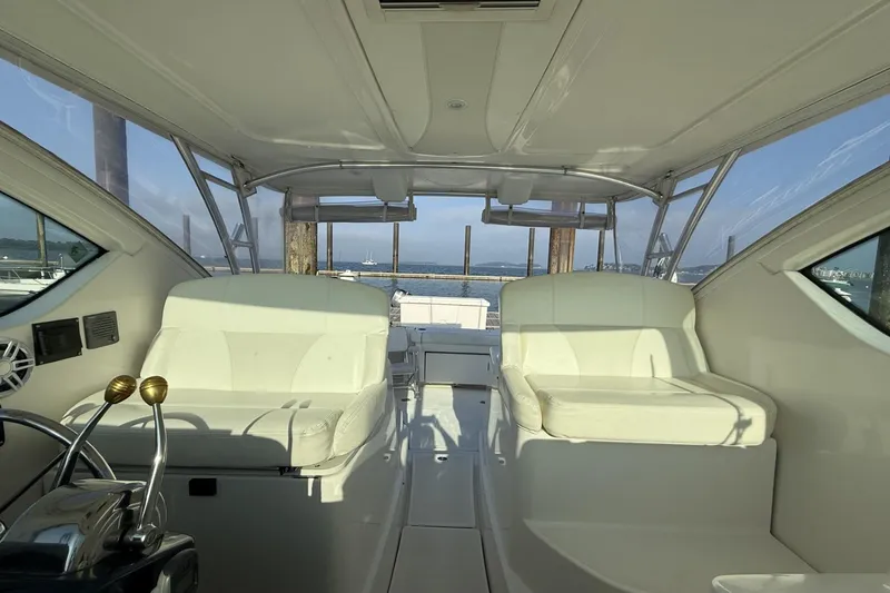 Slide: The Image of 2008 Tiara Yachts 3000 Open interior with white seating and ocean view. - 11