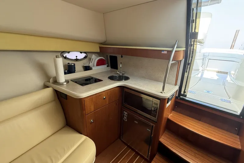 Slide: The Image of 2008 Tiara Yachts 3000 Open interior with kitchenette and seating area. - 16