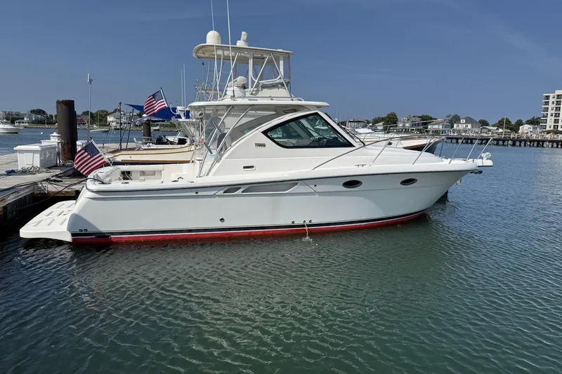 Slide: The Image of 2008 Tiara Yachts 3000 Open docked in a marina, featuring American flags. - 2
