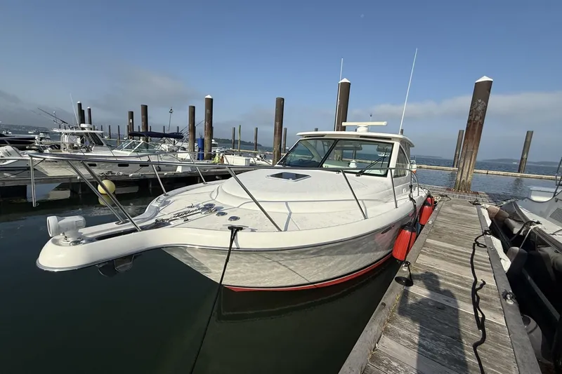 Slide: The Image of 2008 Tiara Yachts 3000 Open docked at marina, clear sky, calm water. - 6
