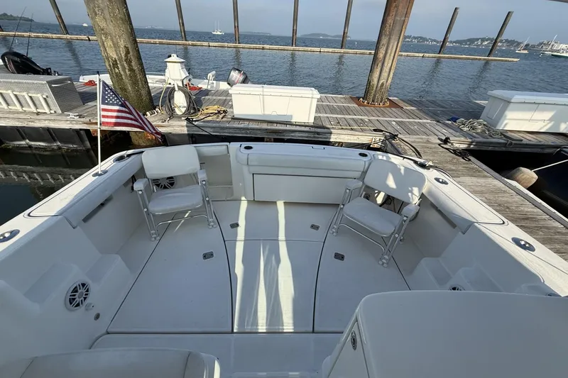 Slide: The Image of 2008 Tiara Yachts 3000 Open at dock, featuring spacious deck and American flag. - 9