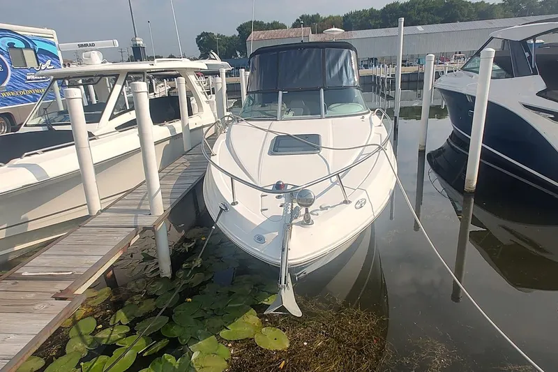 Slide: The Image of 2015 Chaparral 270 Signature boat docked at marina with lily pads nearby. - 1