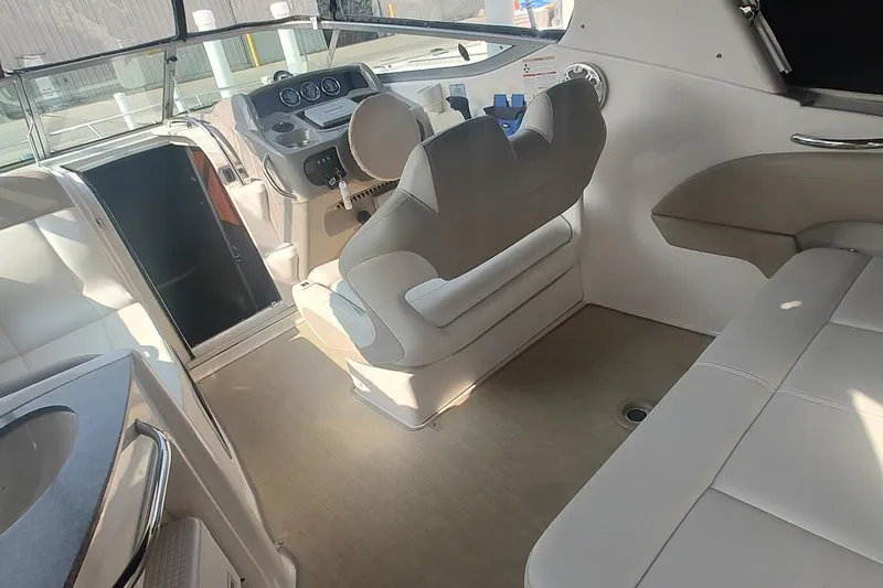 Slide: The Image of Interior of 2015 Chaparral 270 Signature boat with helm and seating area. - 11