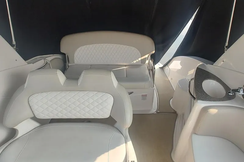 Slide: The Image of 2015 Chaparral 270 Signature boat interior with white seating and compact sink area. - 12