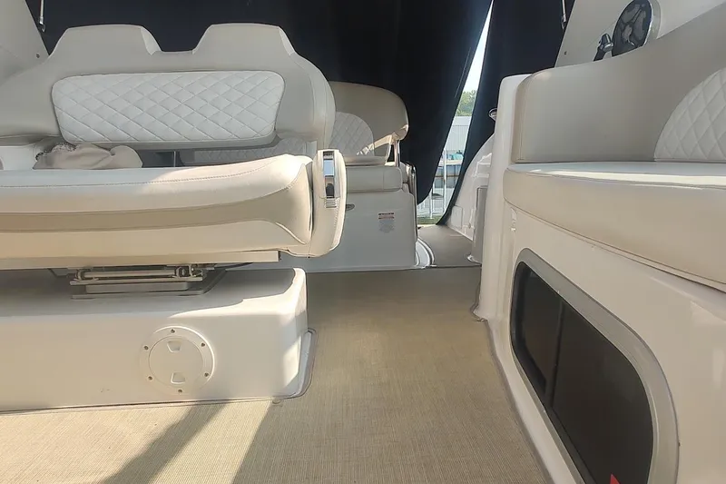 Slide: The Image of Interior of 2015 Chaparral 270 Signature boat with beige seating and carpet. - 13