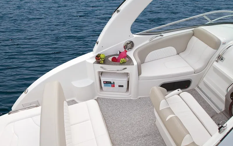 Slide: The Image of Manufacturer Provided Image: 2015 Chaparral 270 Signature boat interior with white seating and ocean backdrop. - 14