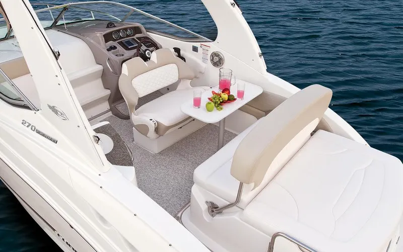 Slide: The Image of Manufacturer Provided Image: 2015 Chaparral 270 Signature boat interior with seating and table on the water. - 15