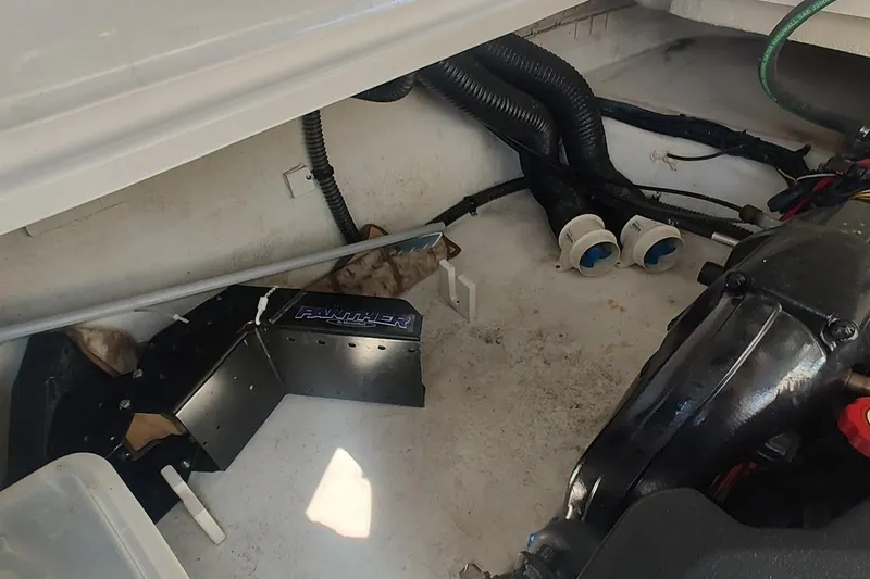 Slide: The Image of Engine compartment of a 2015 Chaparral 270 Signature boat, showing mechanical components. - 20