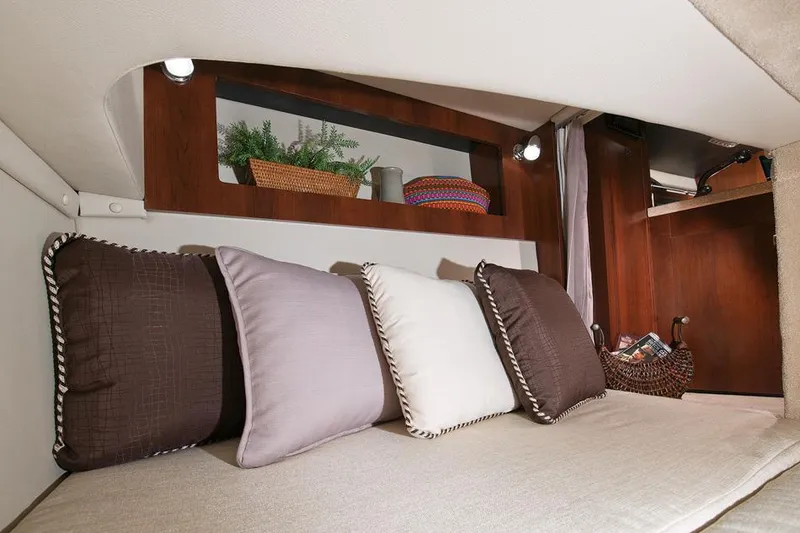 Slide: The Image of Manufacturer Provided Image: Interior cabin of 2015 Chaparral 270 Signature with cushions and storage shelves. - 26