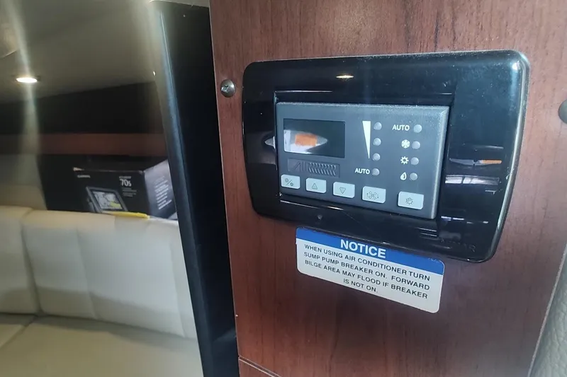 Slide: The Image of Control panel inside 2015 Chaparral 270 Signature boat, featuring air conditioning settings. - 29