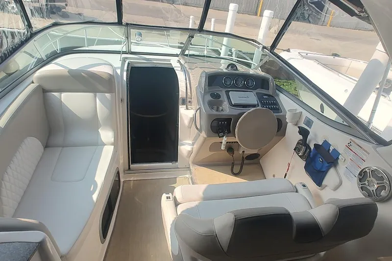 Slide: The Image of 2015 Chaparral 270 Signature boat interior with helm, seating, and dashboard controls. - 7