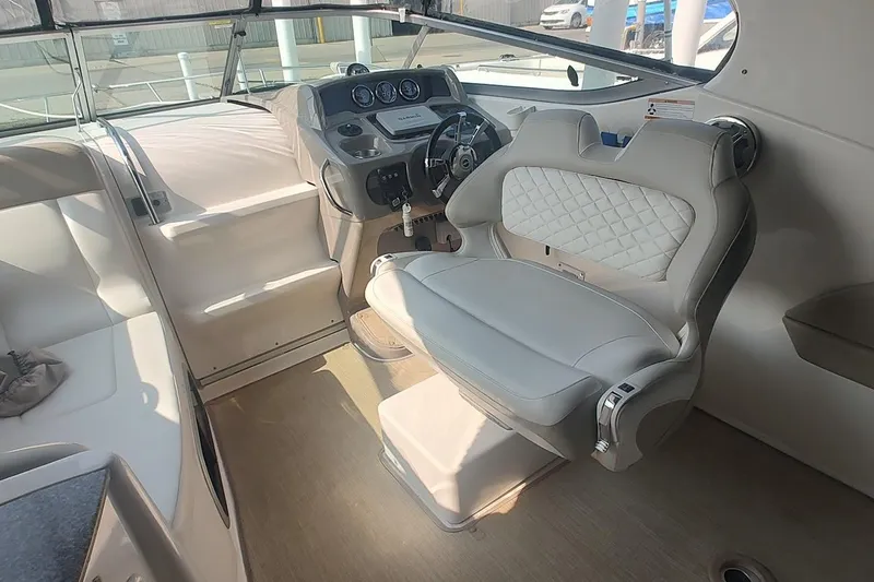 Slide: The Image of Interior of 2015 Chaparral 270 Signature boat with plush seating and modern dashboard. - 9