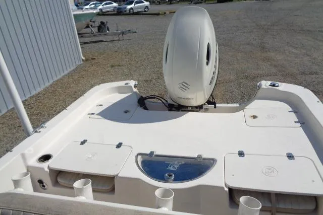 Slide: The Image of 2018 Carolina Skiff 258 DLV boat with Suzuki outboard motor, docked on gravel. - 20