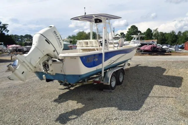 Slide: The Image of 2018 Carolina Skiff 258 DLV boat on trailer, parked on gravel lot. - 7