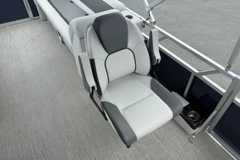 Slide: The Image of 2024 Avalon VENTURE 85 QUAD LOUNGER seat with gray and white upholstery, cup holder, and armrests. - 11