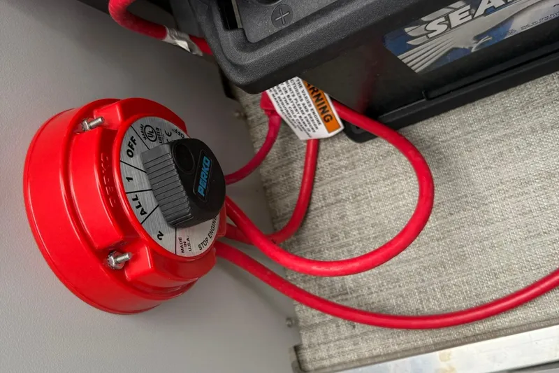 Slide: The Image of Red battery switch and cables in 2024 Avalon VENTURE 85 QUAD LOUNGER boat. - 14