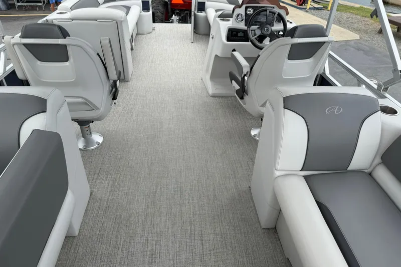 Slide: The Image of 2024 Avalon VENTURE 85 QUAD LOUNGER interior with gray seating and modern helm. - 16