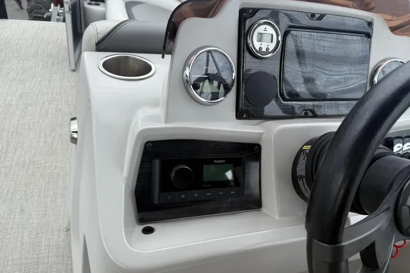 Slide: The Image of 2024 Avalon VENTURE 85 QUAD LOUNGER dashboard with steering wheel and control panel. - 17