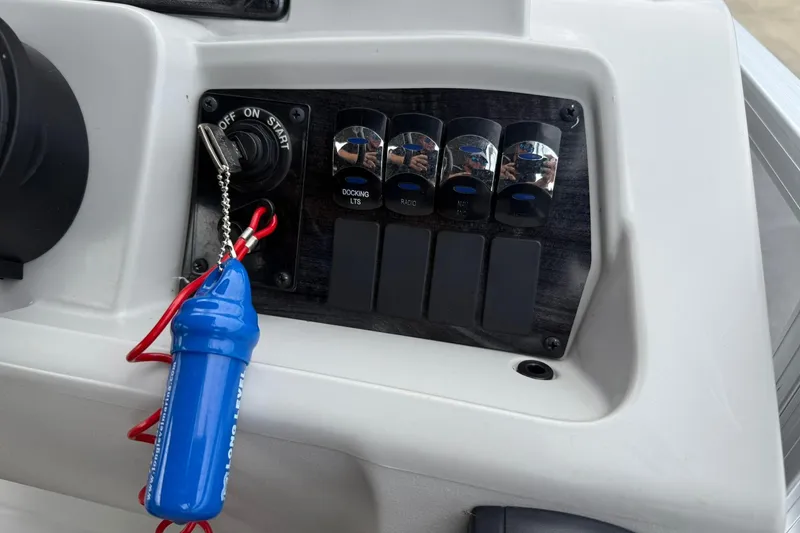 Slide: The Image of Control panel of 2024 Avalon VENTURE 85 QUAD LOUNGER with ignition switch and toggle buttons. - 18