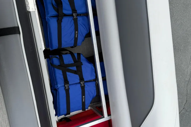 Slide: The Image of Storage compartment with blue life jackets in 2024 Avalon Venture 85 Quad Lounger. - 20