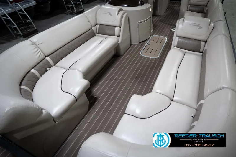 Slide: The Image of 2016 Bennington 2375 GCW pontoon boat interior with luxurious seating and wood-style flooring. - 10