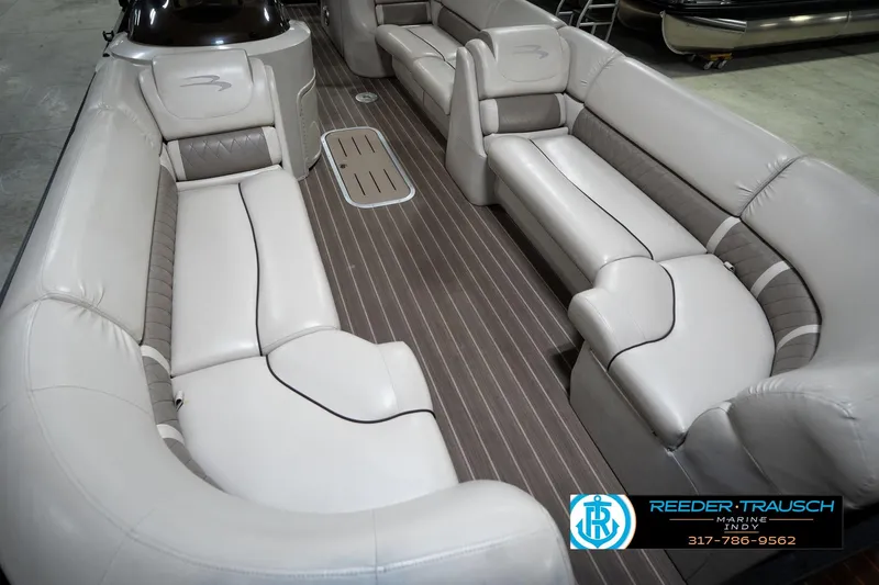 Slide: The Image of 2016 Bennington 2375 GCW pontoon boat interior with plush seating and wood-style flooring. - 11