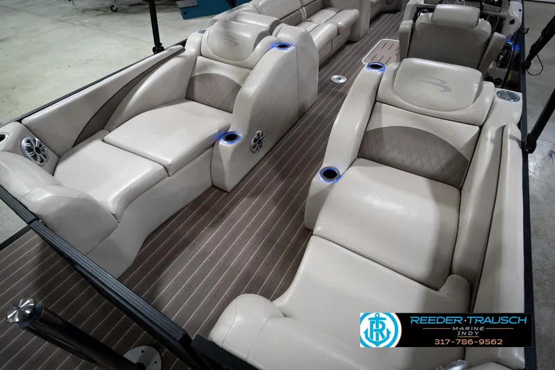 Slide: The Image of 2016 Bennington 2375 GCW boat interior with luxurious beige seating and cup holders. - 12