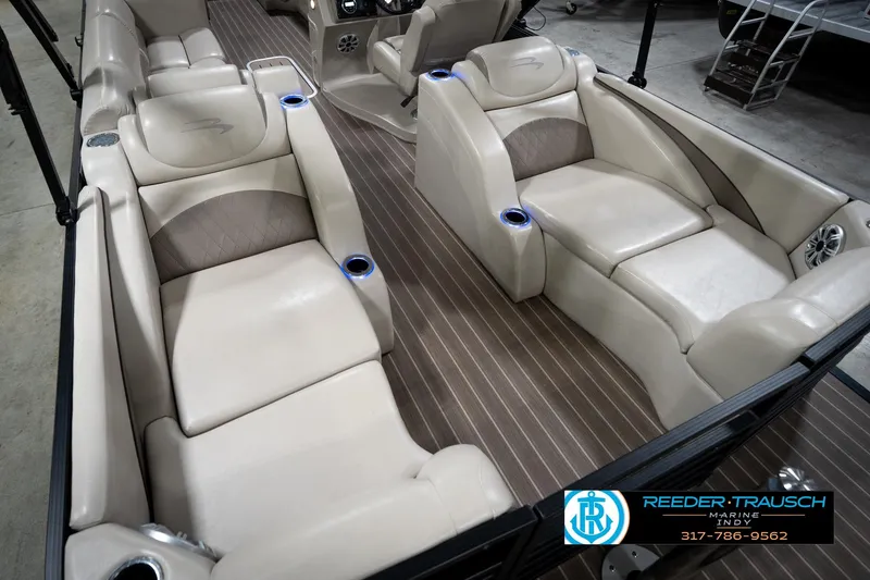 Slide: The Image of 2016 Bennington 2375 GCW pontoon boat interior with luxurious seating and wood-style flooring. - 13