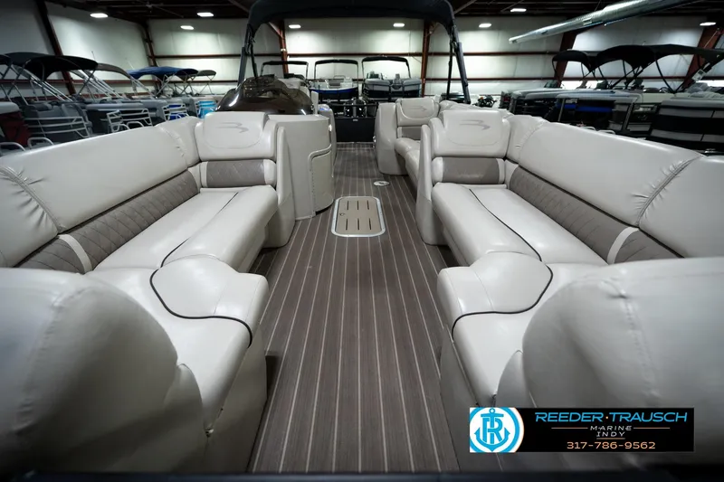 Slide: The Image of 2016 Bennington 2375 GCW pontoon boat interior with luxurious seating and wood-style flooring. - 14