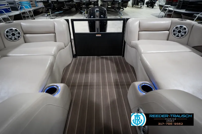 Slide: The Image of 2016 Bennington 2375 GCW pontoon boat interior with beige seating and cup holders. - 16