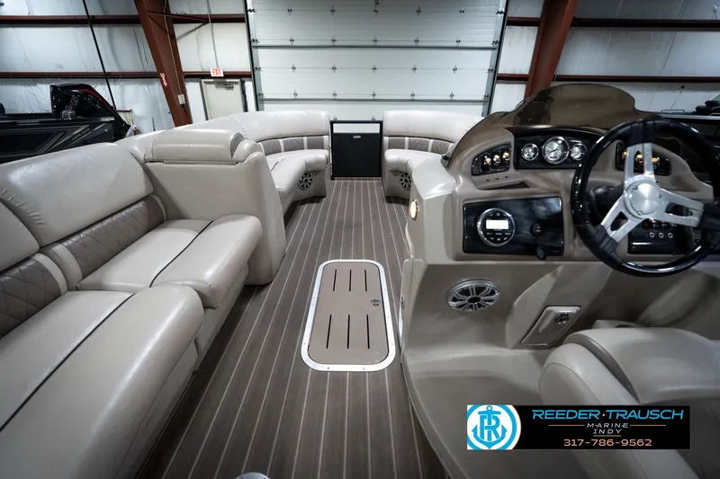 Slide: The Image of 2016 Bennington 2375 GCW boat interior with luxurious seating and modern dashboard. - 18