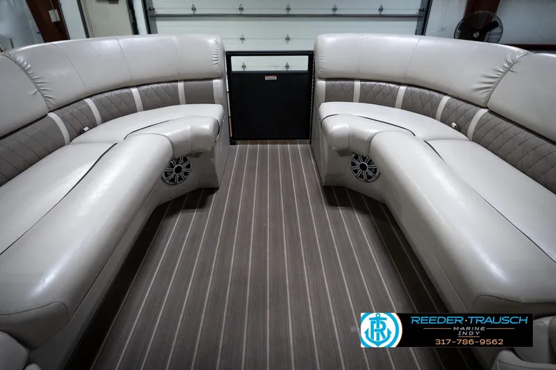Slide: The Image of 2016 Bennington 2375 GCW boat interior with plush seating and striped flooring. - 19