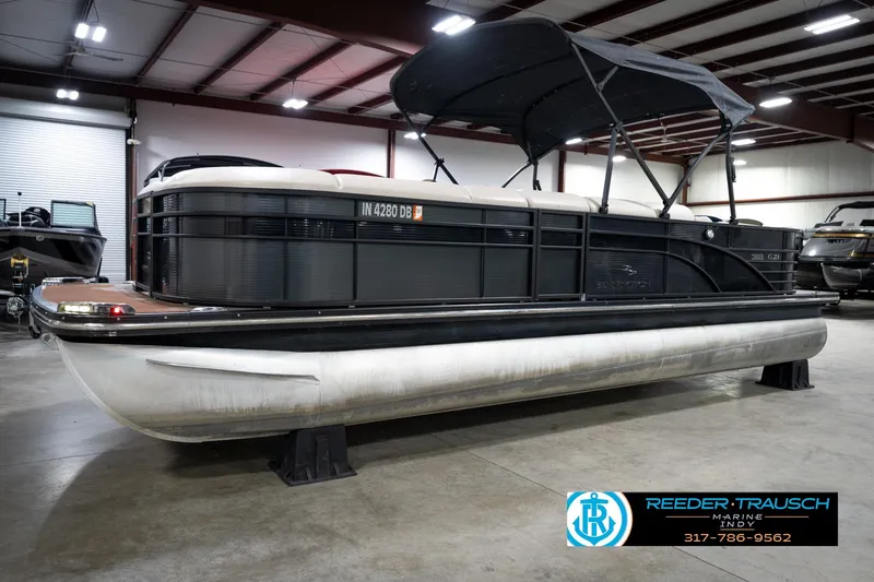 Slide: The Image of 2016 Bennington 2375 GCW pontoon boat in indoor showroom, black exterior, canopy up. - 2