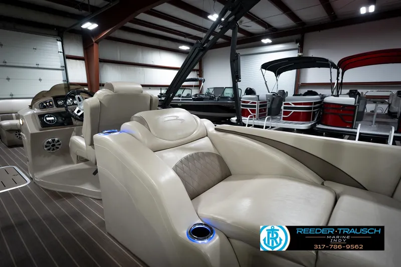 Slide: The Image of 2016 Bennington 2375 GCW pontoon boat interior with luxurious seating and modern dashboard. - 23