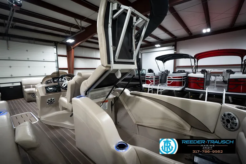 Slide: The Image of 2016 Bennington 2375 GCW pontoon boat interior in showroom with seating and control panel. - 24