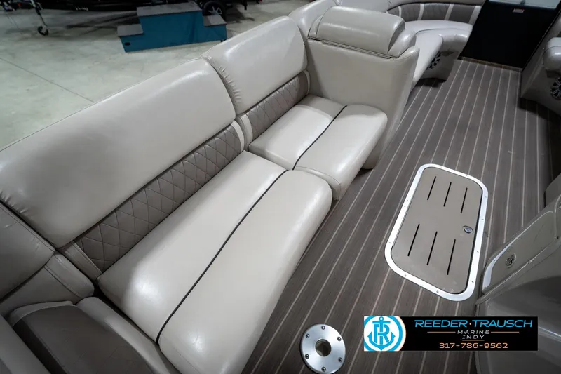 Slide: The Image of 2016 Bennington 2375 GCW boat interior with beige seating and wood-style flooring. - 25