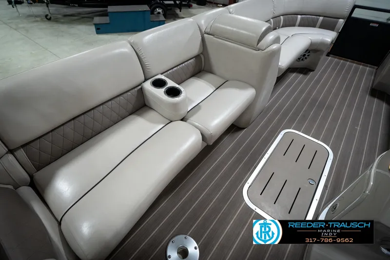 Slide: The Image of 2016 Bennington 2375 GCW pontoon boat interior with beige seating and cup holders. - 26