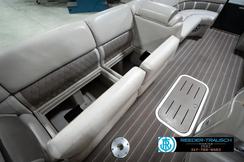 Slide: The Image of 2016 Bennington 2375 GCW boat interior with open storage compartments and sleek seating. - 27