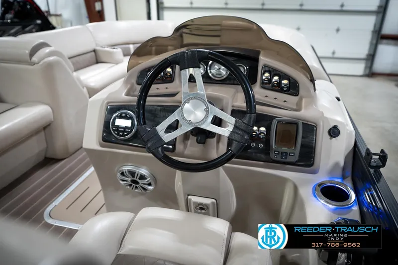 Slide: The Image of 2016 Bennington 2375 GCW boat dashboard with steering wheel and control panel. - 28