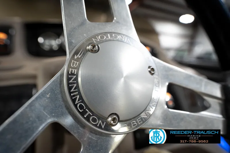 Slide: The Image of Close-up of a 2016 Bennington 2375 GCW steering wheel with logo detail. - 30