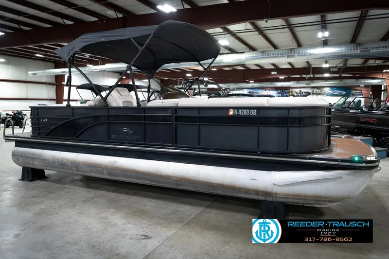 Slide: The Image of 2016 Bennington 2375 GCW pontoon boat in indoor showroom, side view. - 4