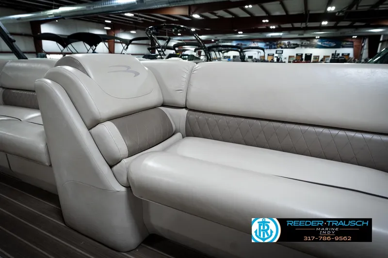 Slide: The Image of 2016 Bennington 2375 GCW boat interior with luxurious beige seating in showroom. - 43