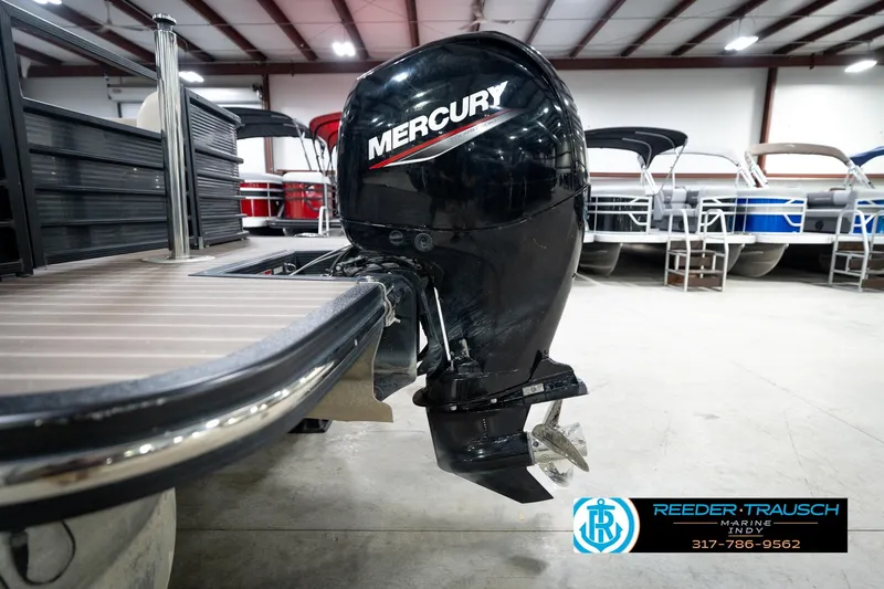 Slide: The Image of 2016 Bennington 2375 GCW pontoon boat with Mercury outboard motor in showroom. - 50
