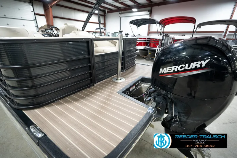 Slide: The Image of 2016 Bennington 2375 GCW pontoon boat with Mercury outboard motor in showroom. - 58