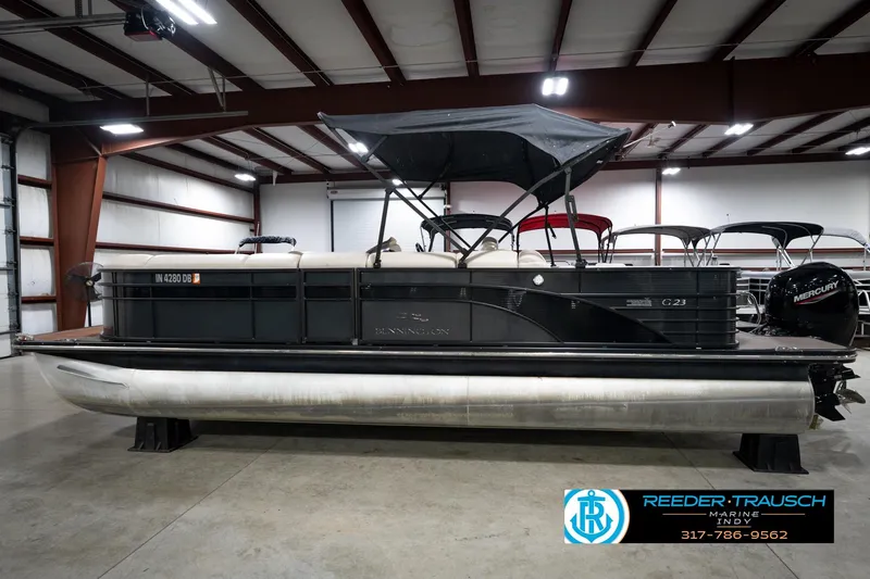 Slide: The Image of 2016 Bennington 2375 GCW pontoon boat in indoor showroom, side view. - 9