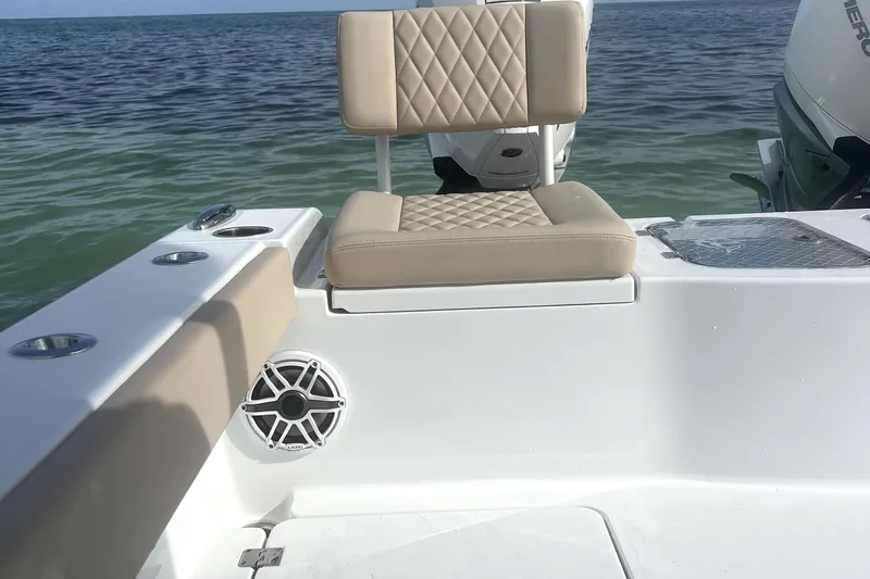 Slide: The Image of 2024 Freeman 28 boat interior with beige seating and ocean backdrop. - 11